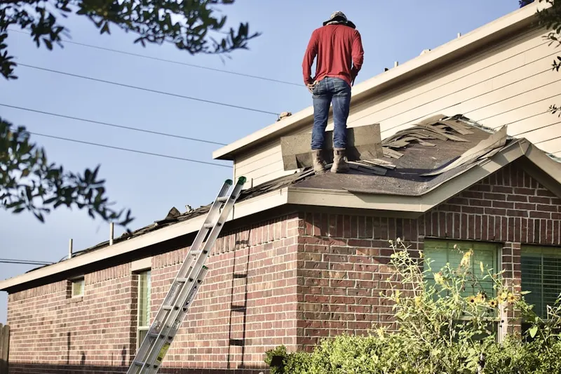 Professional roofer working on a residential roof in Jugtown